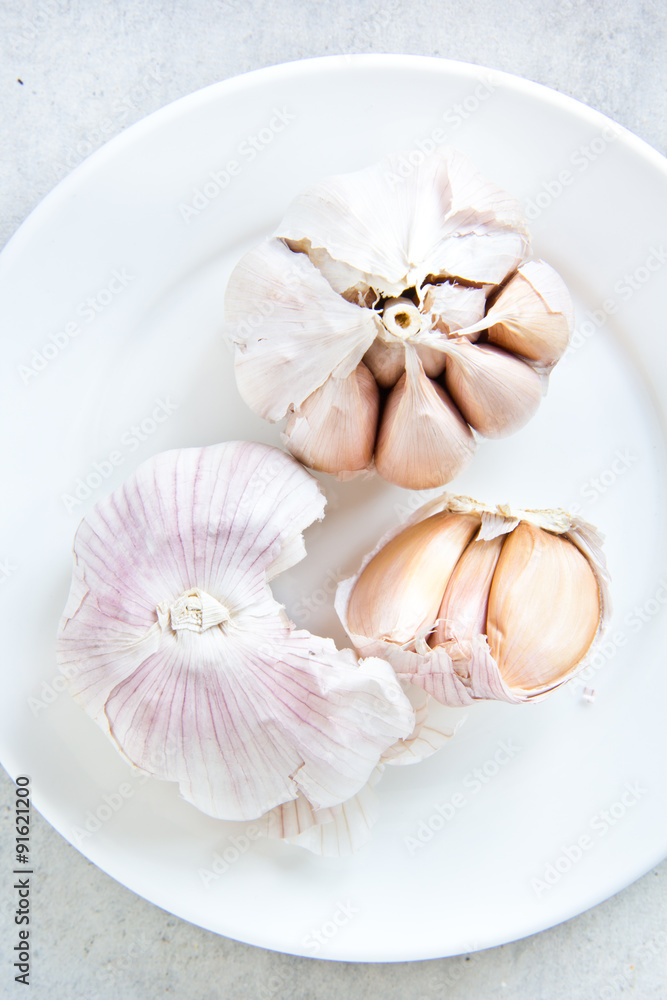 Garlic on white plate Garlic on white plate
