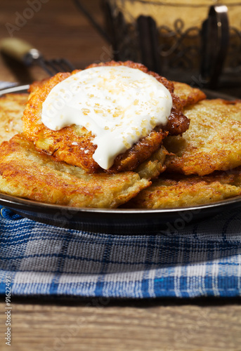 Homemade potato pancakes served with sour cream and brown sugar