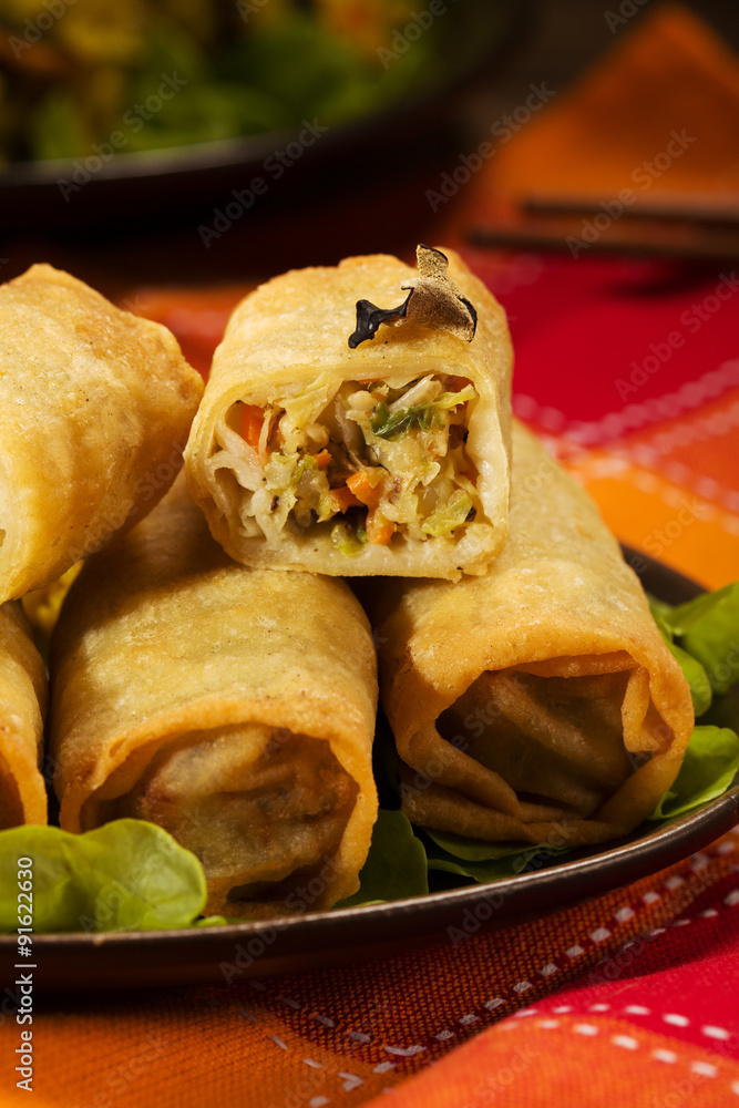 Portion baked spring rolls with vegetables and rice on a plate. Portion baked spring rolls with vegetables and rice on a plate.