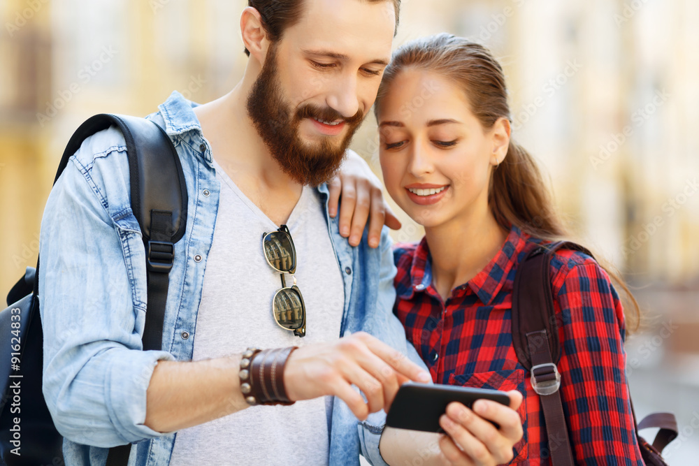 Fototapeta premium Pleasant couple holding mobile phone 