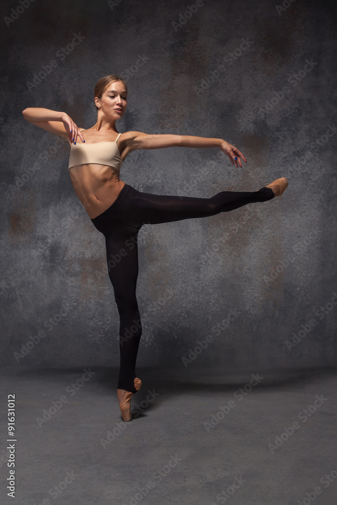 Young beautiful modern style dancer posing on a studio Young beautiful modern style dancer posing on a studio