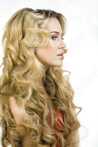 beauty blond woman with long curly hair close up isolated
