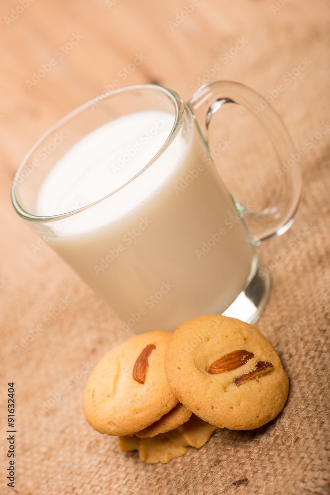 cup of milk wite cookies on wood table cup of milk wite cookies on wood table