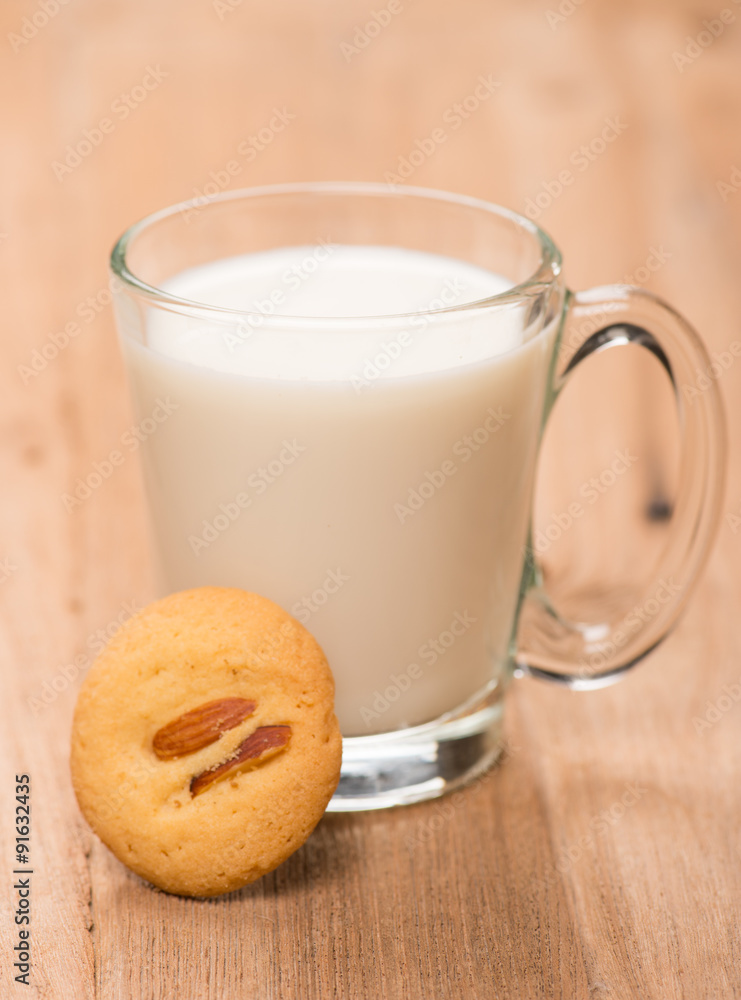 cup of milk wite cookies on wood table cup of milk wite cookies on wood table