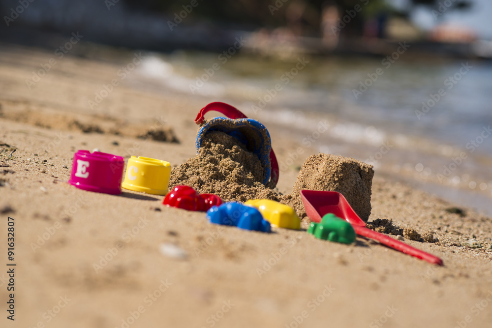 Plastic children toys in sandpit or on a beach Plastic children toys in sandpit or on a beach