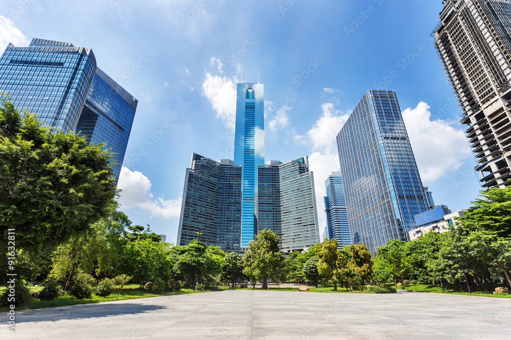 modern square and skyscrapers under blue sky