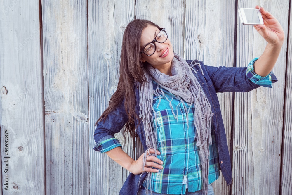 Fototapeta premium Happy hipster holding a mobile phone