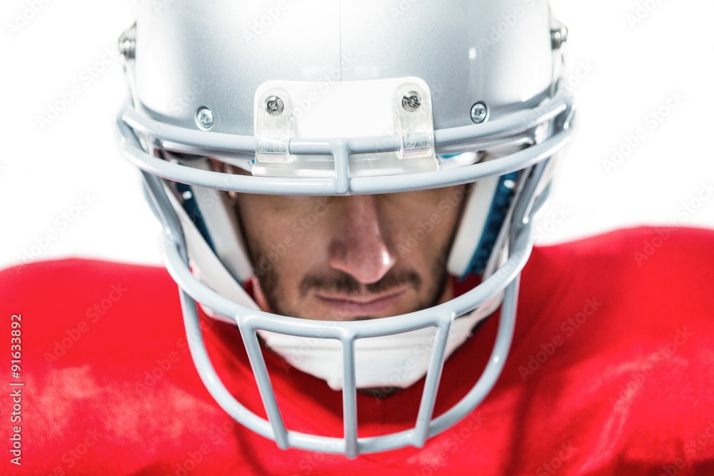 Close-up of American football player in red jersey looking down Close-up of American football player in red jersey looking down