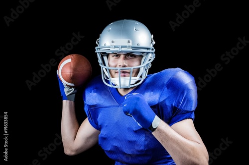 Portrait of sportsman smiling while throwing ball