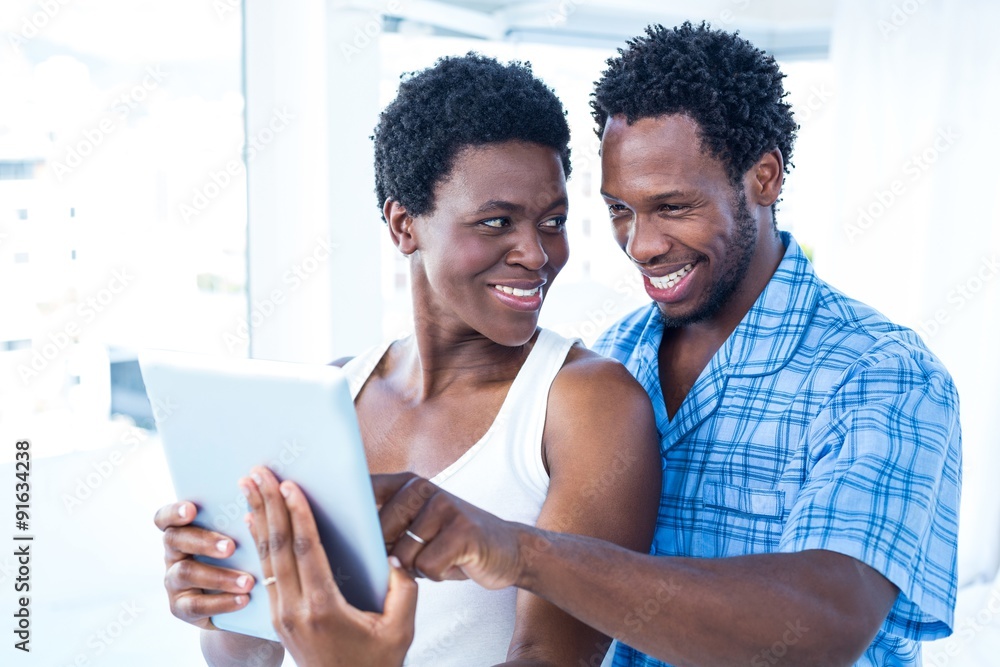 Husband pointing towards digital tablet at home Husband pointing towards digital tablet at home