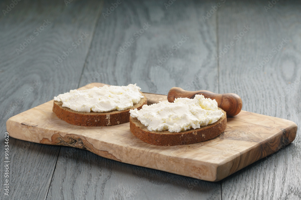 rye bread with cream cheese on wood table rye bread with cream cheese on wood table