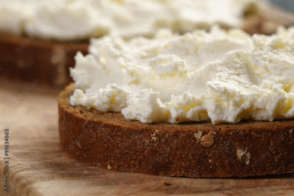 rye bread with cream cheese on wood table
