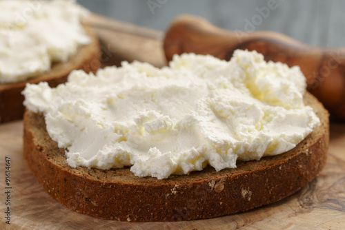 rye bread with cream cheese on wood table