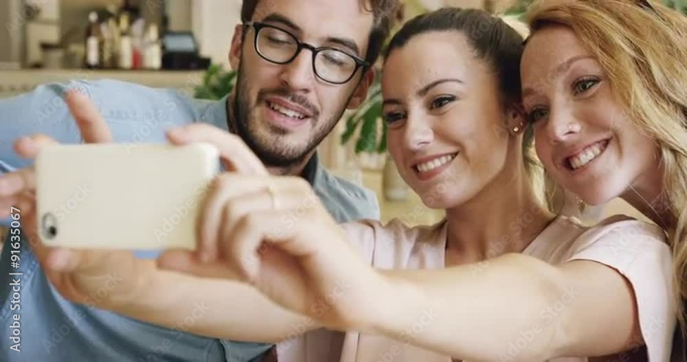 Beautiful people taking selfie in cafe mobile phone Beautiful people taking selfie in cafe mobile phone