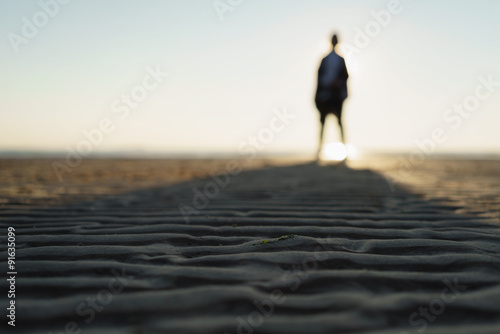 defocused photo of girl standing on beach
