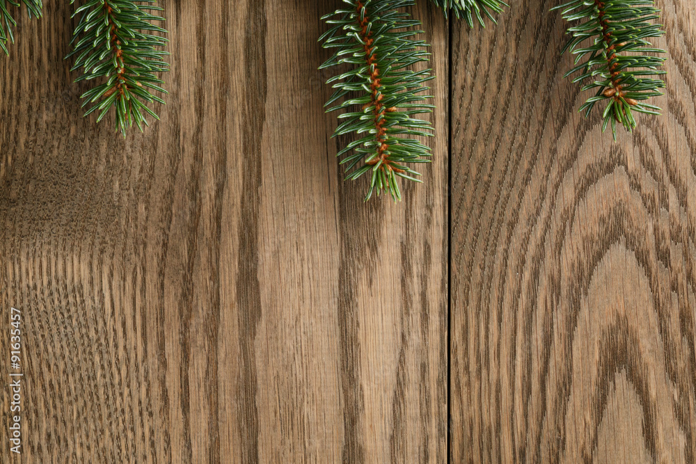 fir branch on wooden oak table from above fir branch on wooden oak table from above