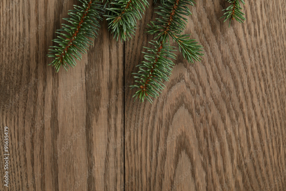 fir branch on wooden oak table from above fir branch on wooden oak table from above