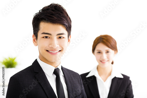 happy business man and woman standing in office