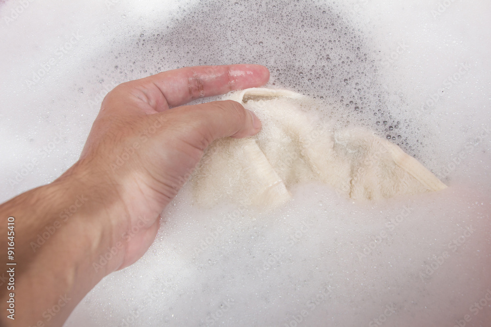 Hand washing clothes with soapy water Hand washing clothes with soapy water
