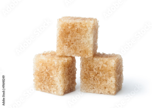 Brown cane sugar cubes isolated on white background