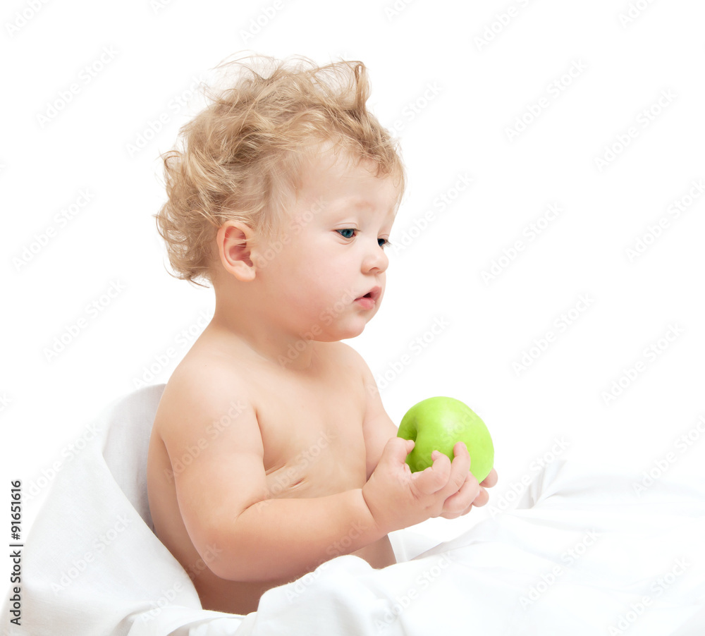 little curly-headed child holding a green apple on white backgro little curly-headed child holding a green apple on white backgro