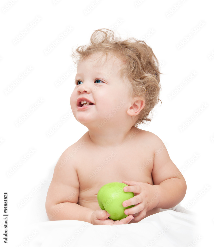 little curly-headed child holding a green apple on white backgro little curly-headed child holding a green apple on white backgro