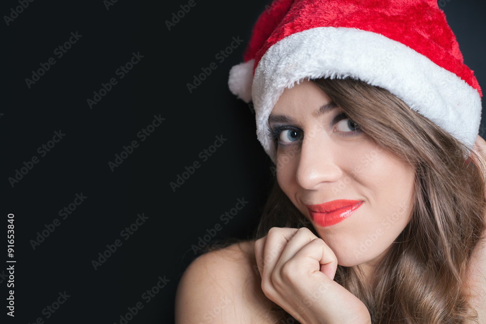 Pretty woman dressed in Santa Claus hat Pretty woman dressed in Santa Claus hat