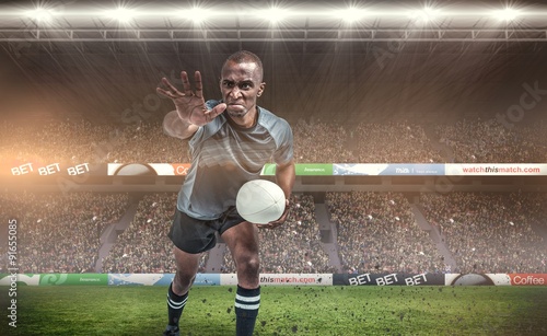 Composite image of aggressive rugby player gesturing