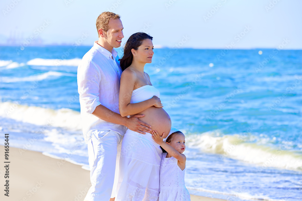 Family on the beach pregnant mother