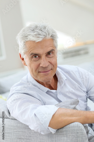 Portrait of elderly man relaxing in sofa at home