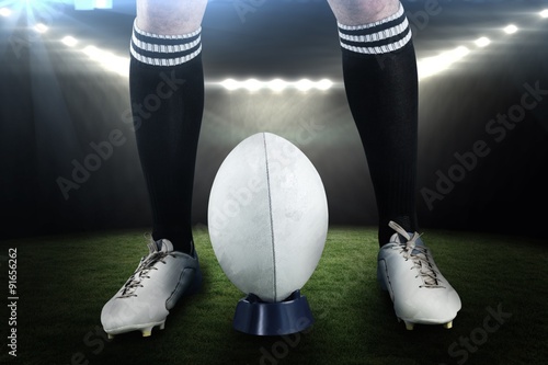 Composite image of low section of sportsman playing rugby