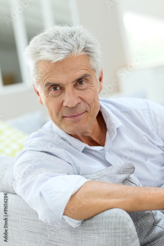 Portrait of elderly man relaxing in sofa at home