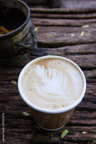 Fototapeta Naklejka Na Ścianę i Meble -  A Cup of hot latte art coffee on wooden table