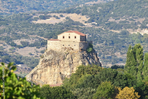 the church of Our Lady of the Sweet Kiss sits atop a rock outcrop above the town of Petra, Lesbos
