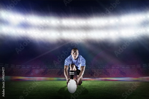 Composite image of portrait of rugby player kneeling