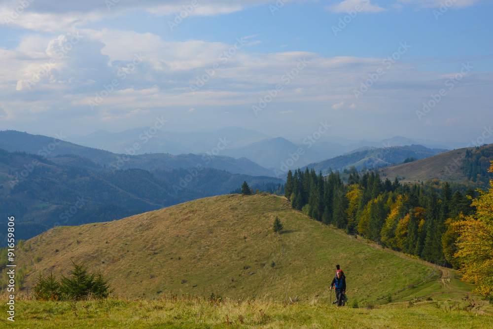 Hikers are walking to the autumn mountains .