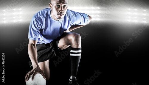 Composite image of serious rugby player kneeling © vectorfusionart