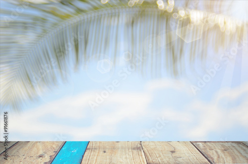 blur beach with palm leaf abstract background © tonktiti