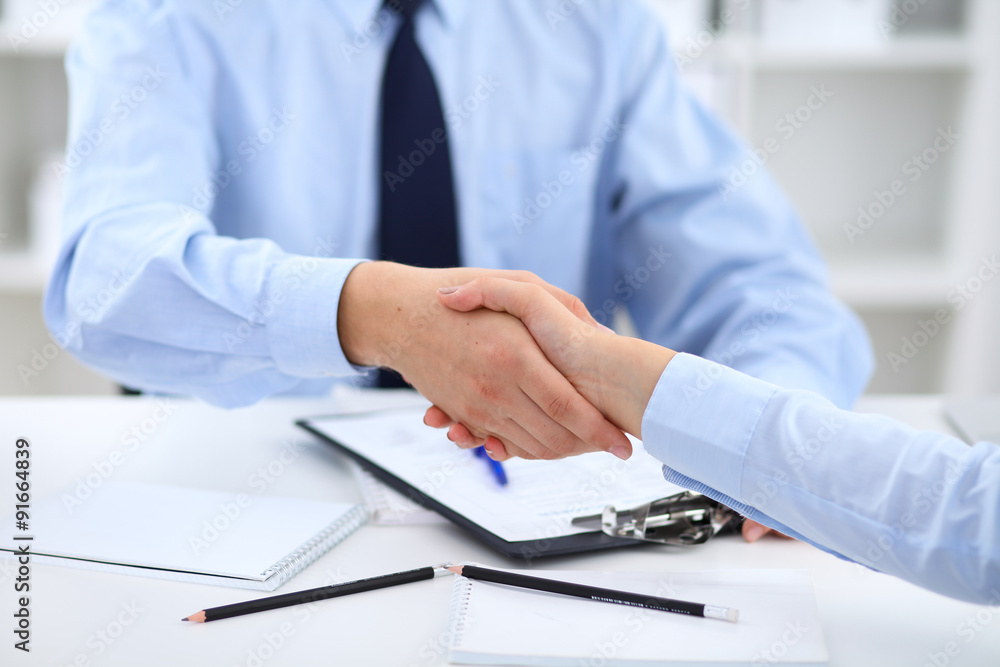 Business people shaking hands, finishing up a meeting Business people shaking hands, finishing up a meeting