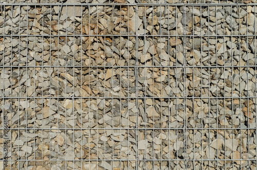 Gabion retaining wall - grey stones in gabion baskets kept by retaining wall wire mesh
