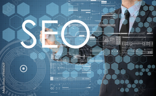 the businessman is writing SEO on the transparent board with som