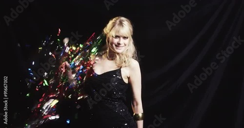 Attractive women dancing is blasted with colored confetti party black background Red Epic Dragon