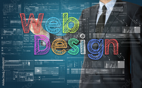 the businessman is writing Web Design with colorful font on the photo