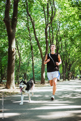 work out with dog. Young caucasian male running with siberian hu