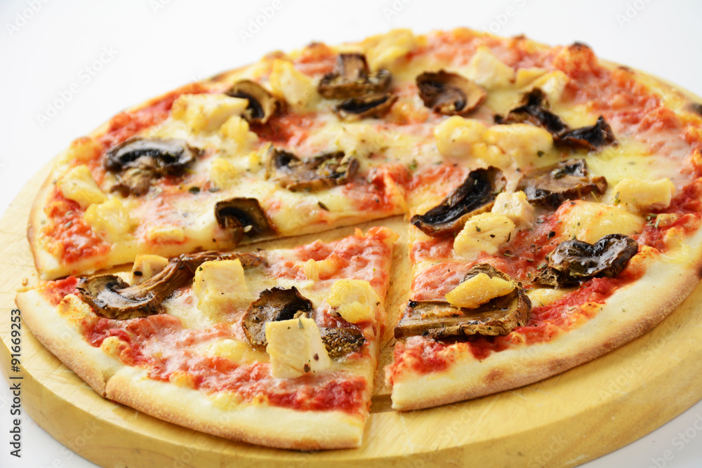 Pizza with mushroom and chicken on round wooden plank, studio isolated Pizza with mushroom and chicken on round wooden plank, studio isolated