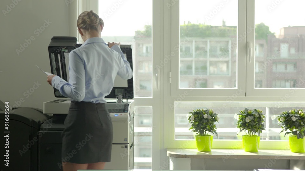 Busy business woman at work in office, businesswoman making copies of