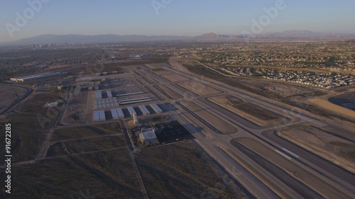 Aerial view of a small airport near Las Vegas, Nevada with suburban sprawl in the distance.