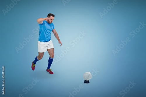 Composite image of rugby player ready to kick