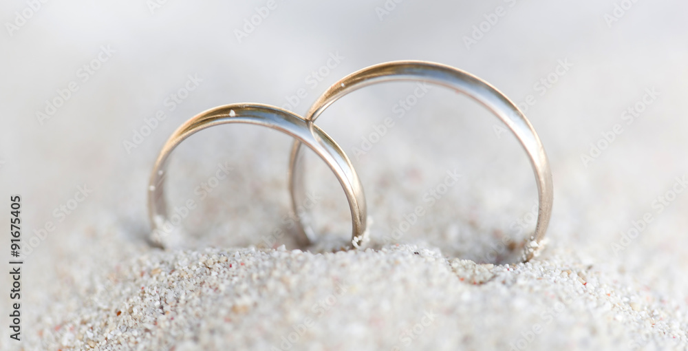 Wedding rings in sand on beach Wedding rings in sand on beach
