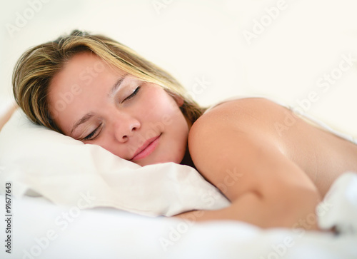 Beautiful woman sleeps in the bedroom